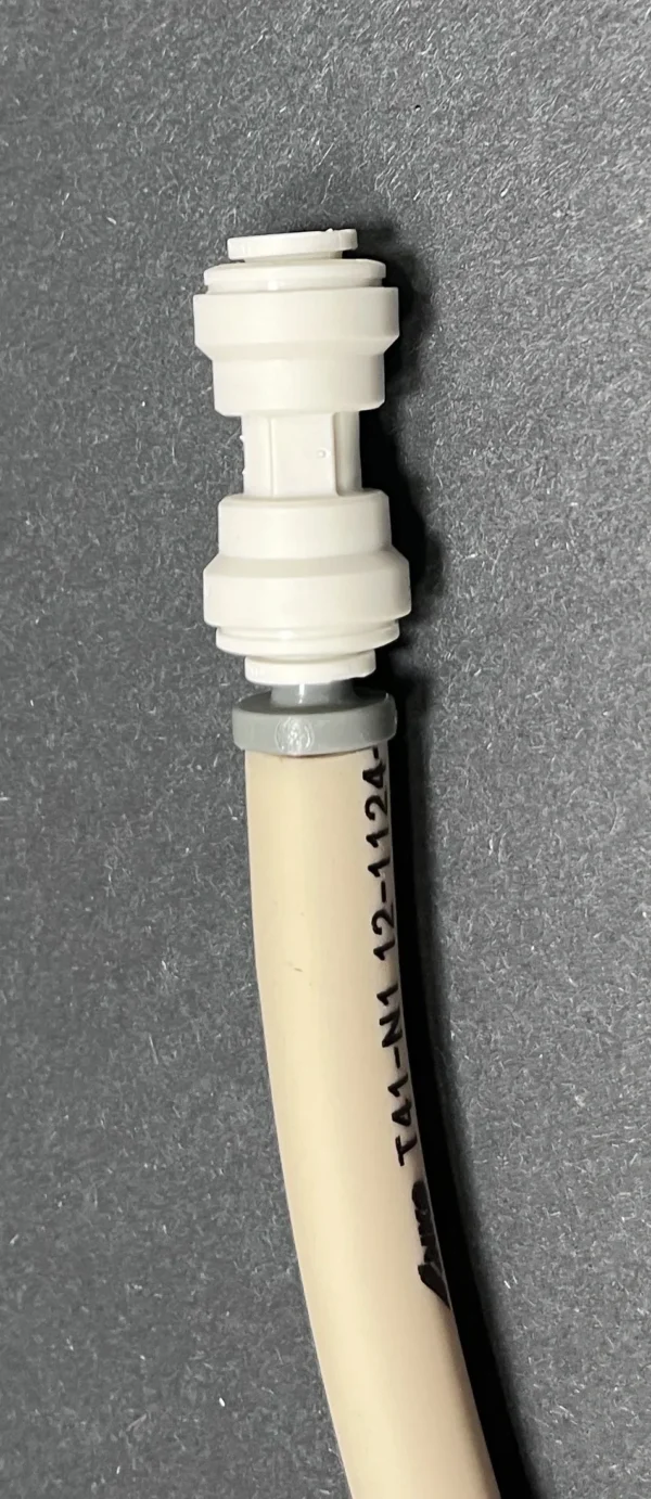 Here's an alt tag for the image: Push-to-connect fitting on tubing.