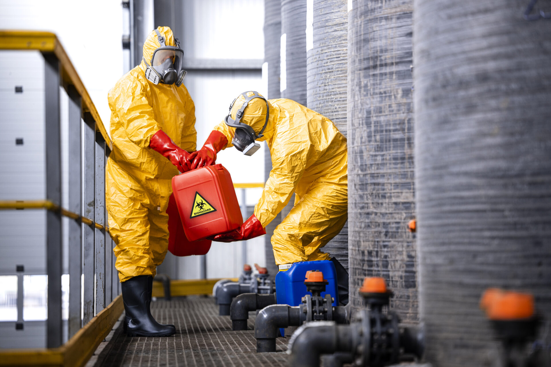 Workers in hazmat suits handle biohazard.